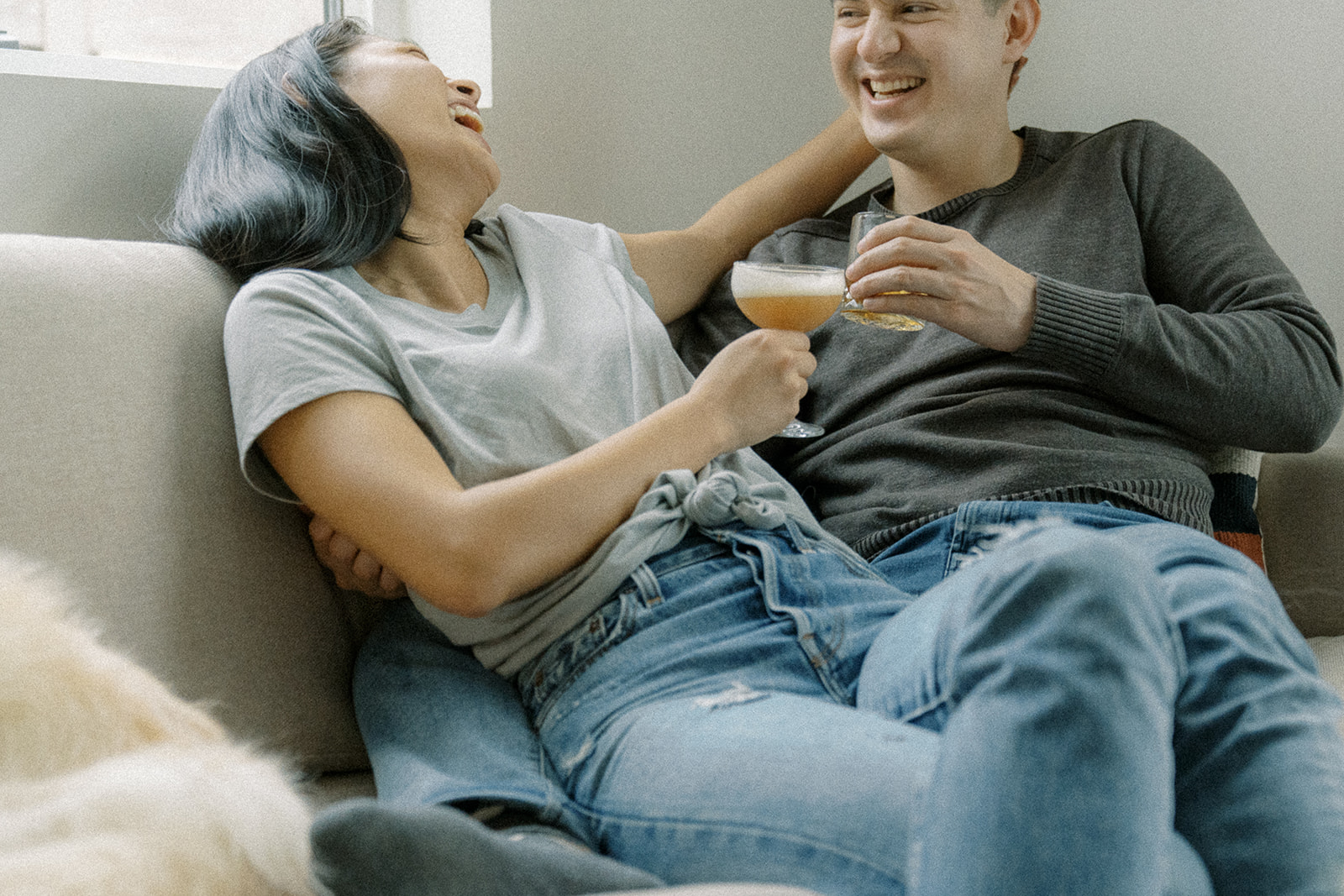 a couple's engagement photos at home with cocktails
